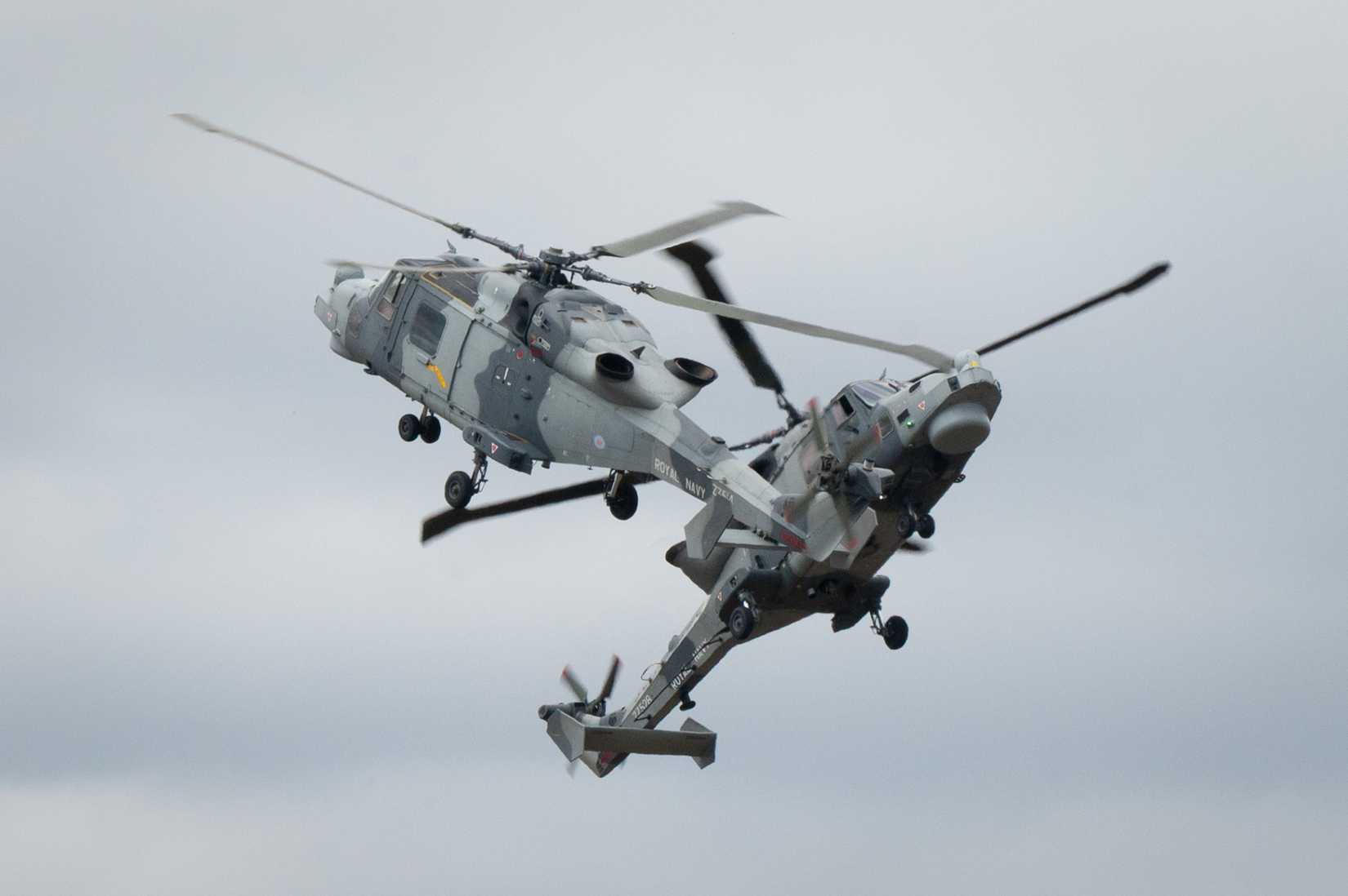 Two Royal Navy Wildcats perform an aerial maneuver during the Royal International Air Tattoo (RIAT) at RAF Fairford, England, July 18, 2025