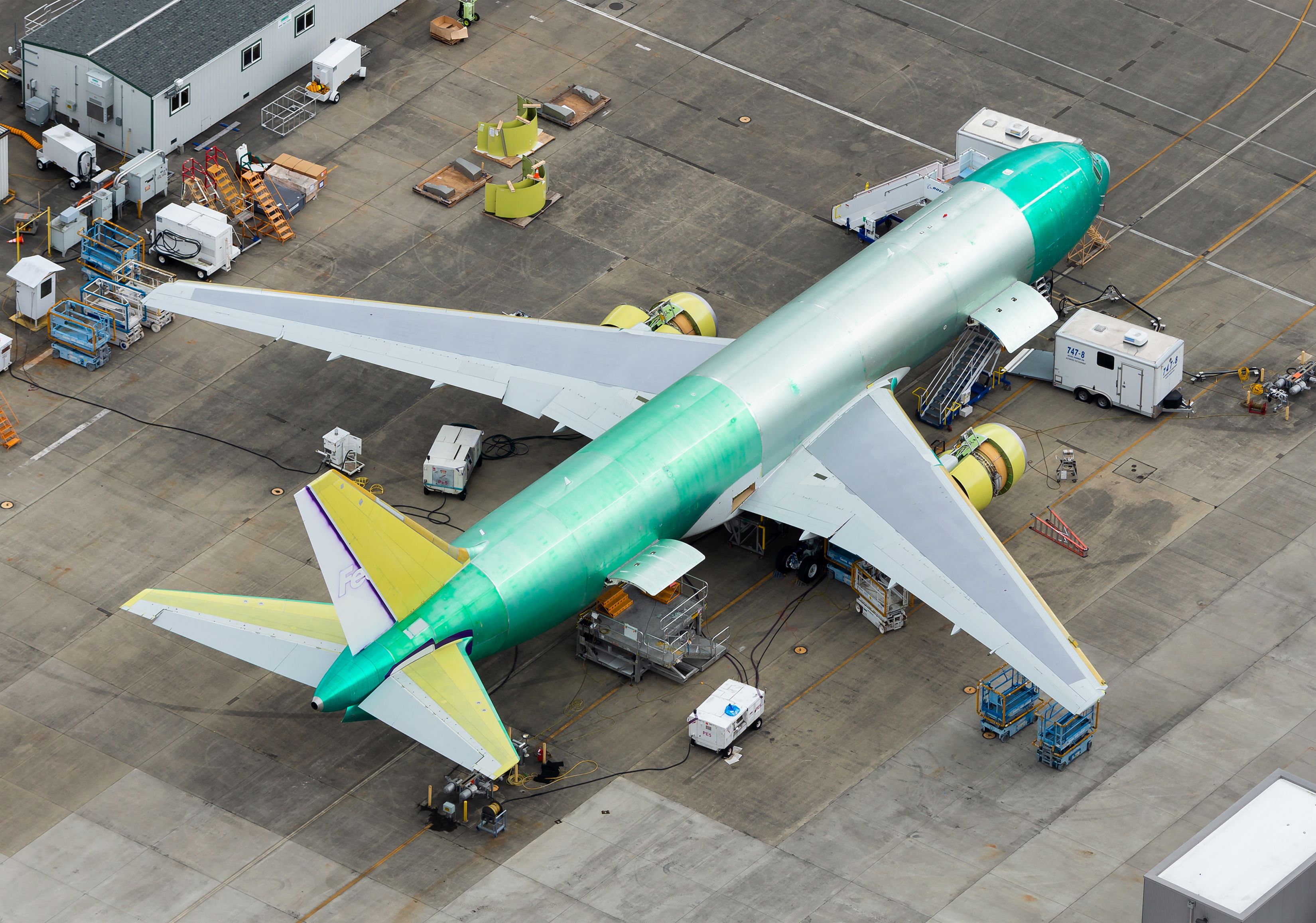 Unpainted Boeing 767 cargo aircraft being prepared for paint before delivery.