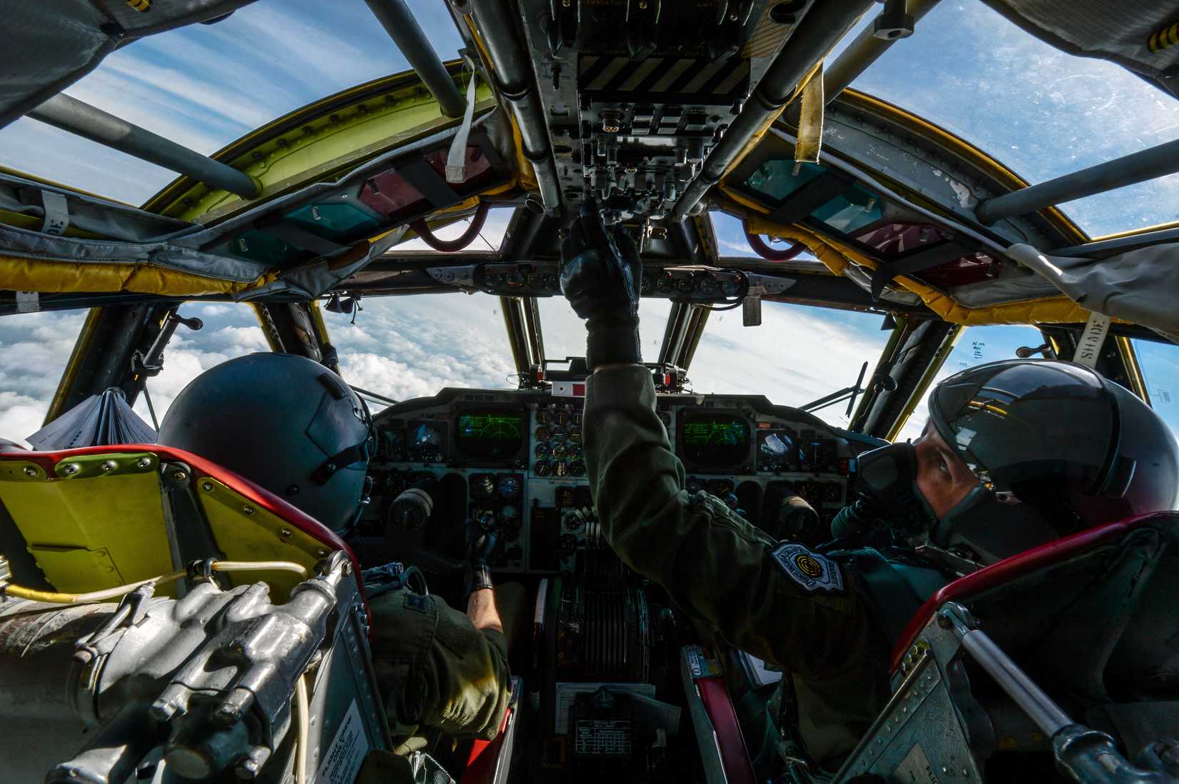 A photo of the B-52 cockpit with the pilot flying the aircraft at high altitude.