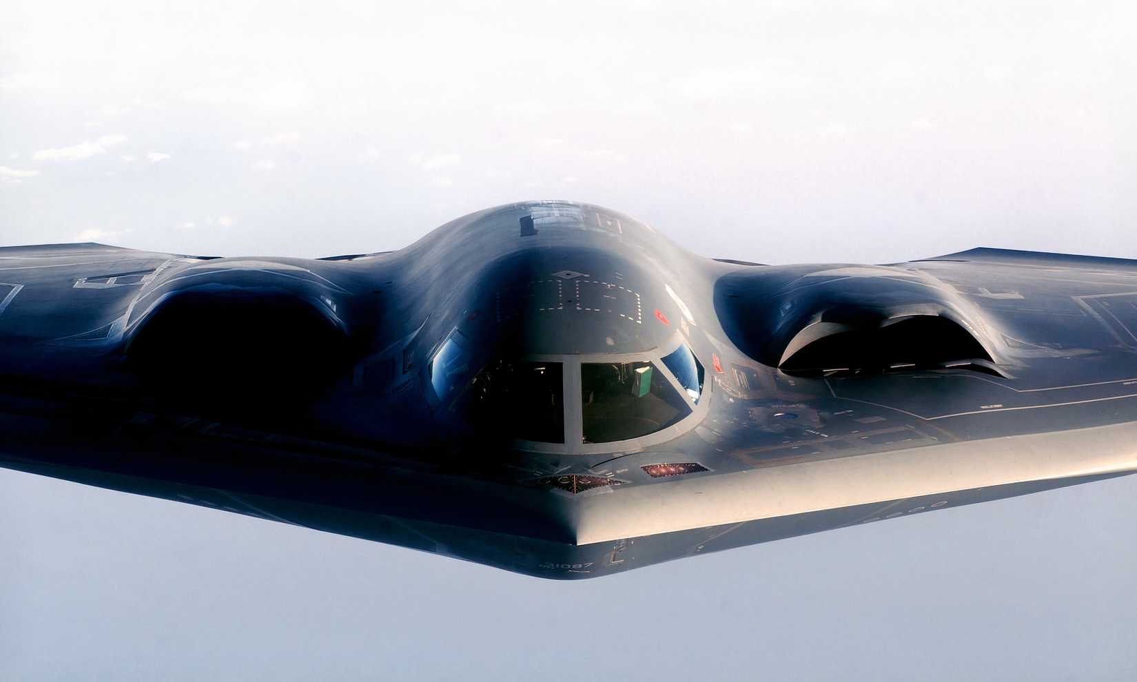 A photo displaying a close-up shot of the B-2s cockpit and engine intakes.