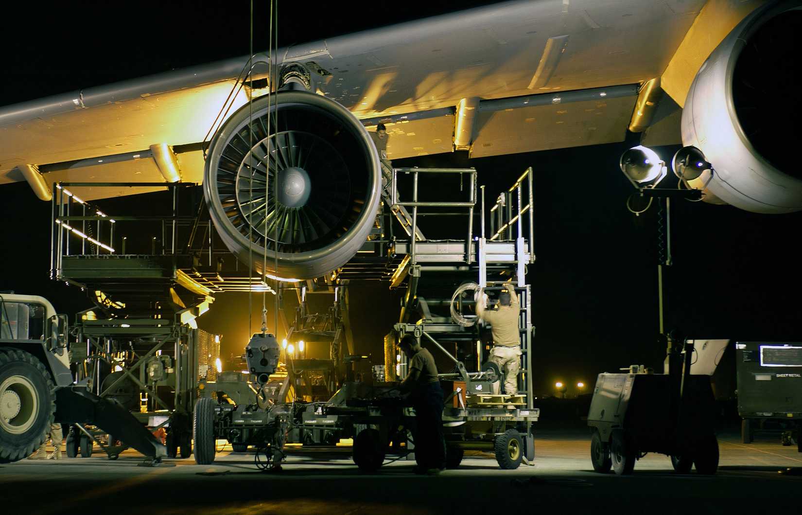 A photo of airmen working into the night to remove and replace a C-5 Galaxy engine during Operation Iraqi Freedom.
