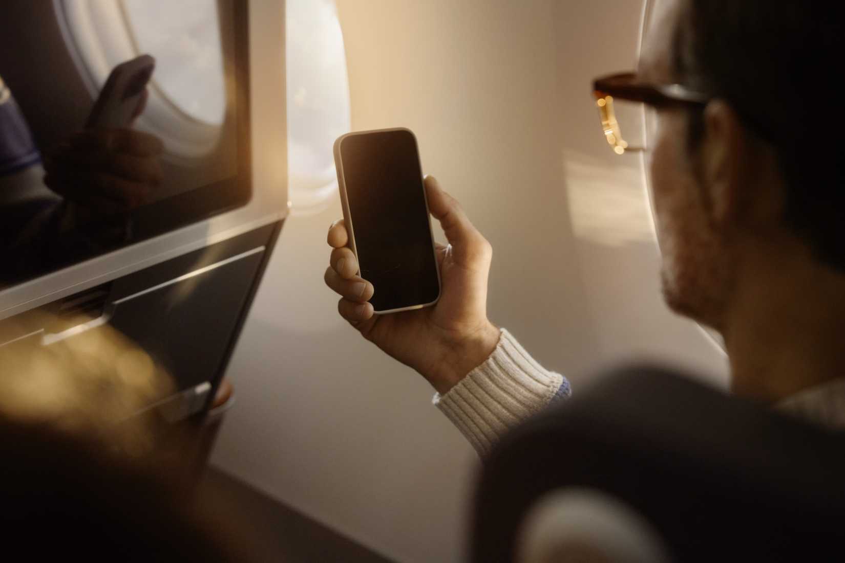 Lufthansa Passenger On Phone Rear View