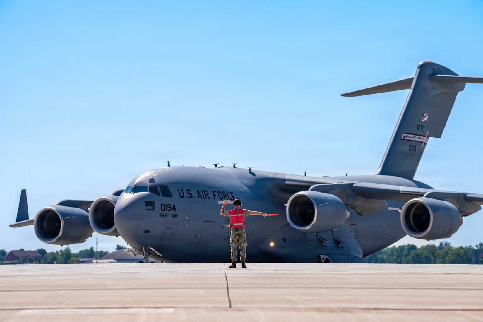 445th Aircraft Maintenance Squadron crew chief, marshals in C-17 Globemaster III aircraft tail 0194, assigned to the wing, after landing at Wright-Patterson Air Force Base