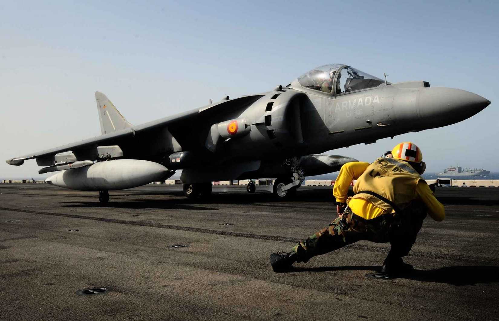 A sailor conducts final pre-flight checks on an AV-8B Harrier assigned to the 9th Spanish Harrier Squadron