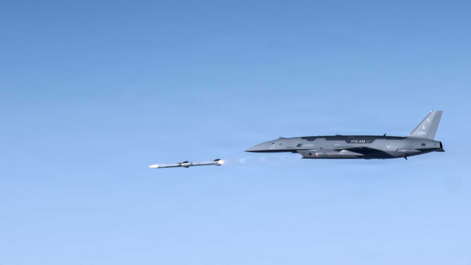 A YFQ-44A Collaborative Combat Aircraft fires an AIM-120 weapon in secluded airspace over the Mojave Desert. The