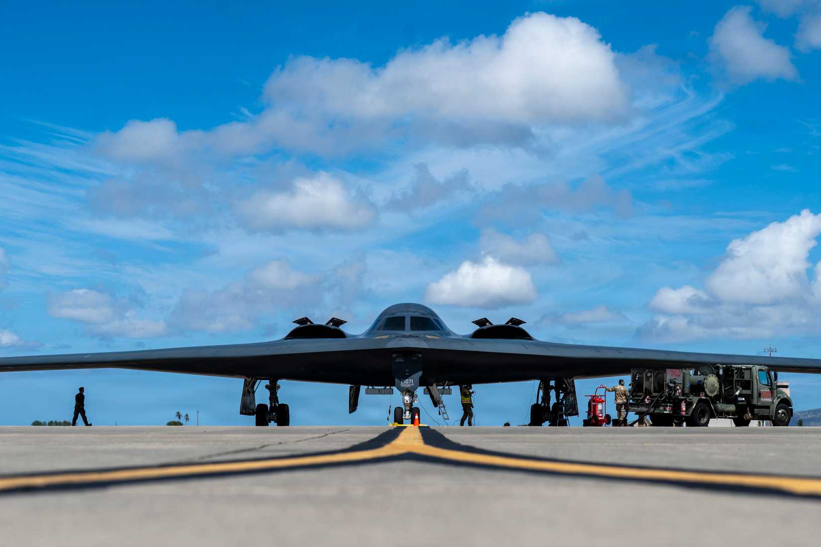 Air Force Airmen assigned to the 393rd Expeditionary Bomb Squadron conduct hot-pit refueling operations for a B-2 Spirit.