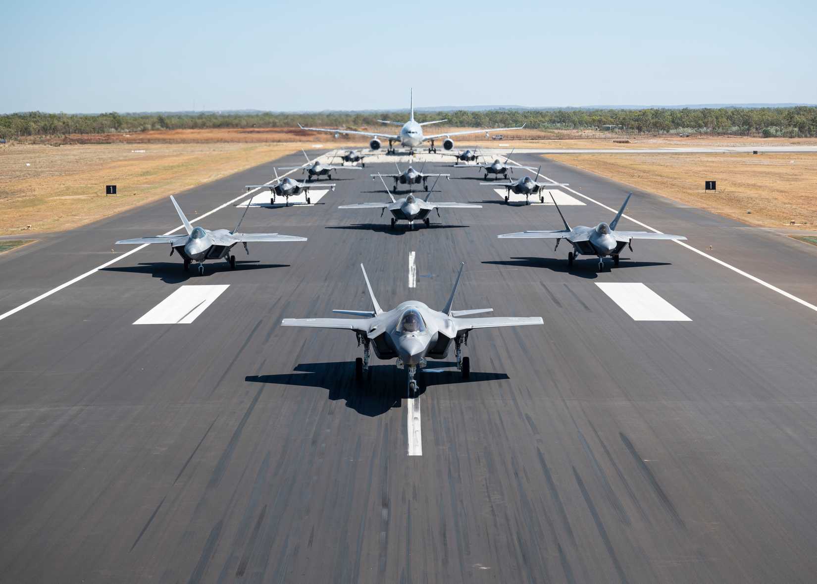 Air Force F-22A Raptors along with Royal Australian Air Force F-35A Lightning IIs and a KC-30A  demonstrate a show of force