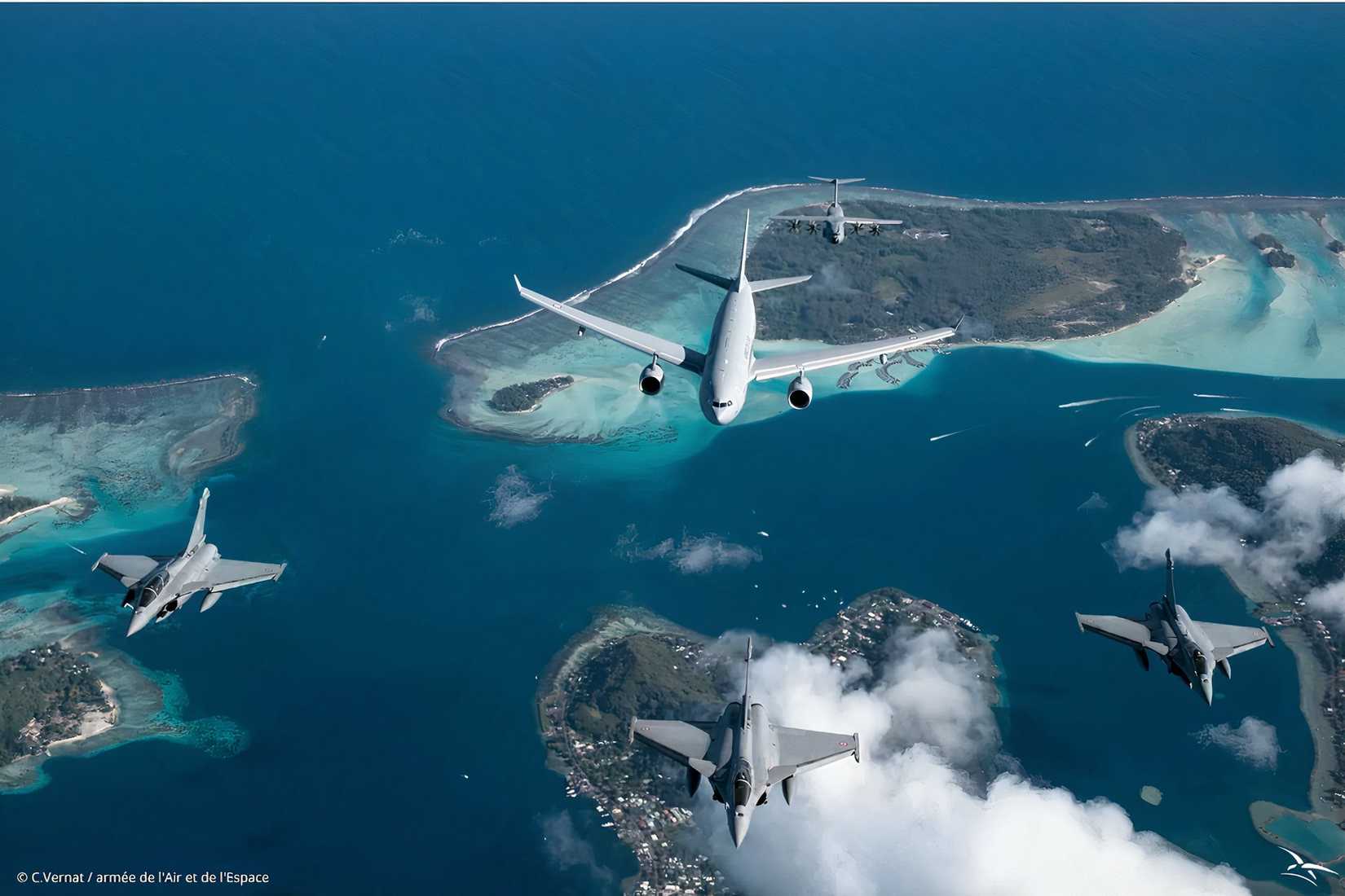 A photo showing an Airbus A330 MRTT flying over islands with three Eurofighter Typhoon's in front of it. 