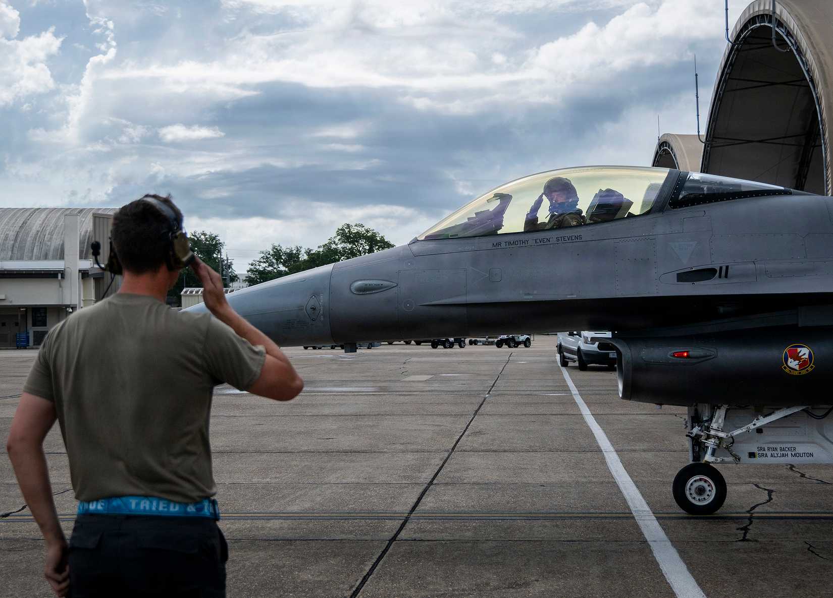 Airman 1st Class Landon Campbell, 96th Aircraft Maintenance Squadron, salutes Tim Stevens, 40th Flight Test Squadron test pilot, as he taxis out for a VENOM test flight June 26, 2026