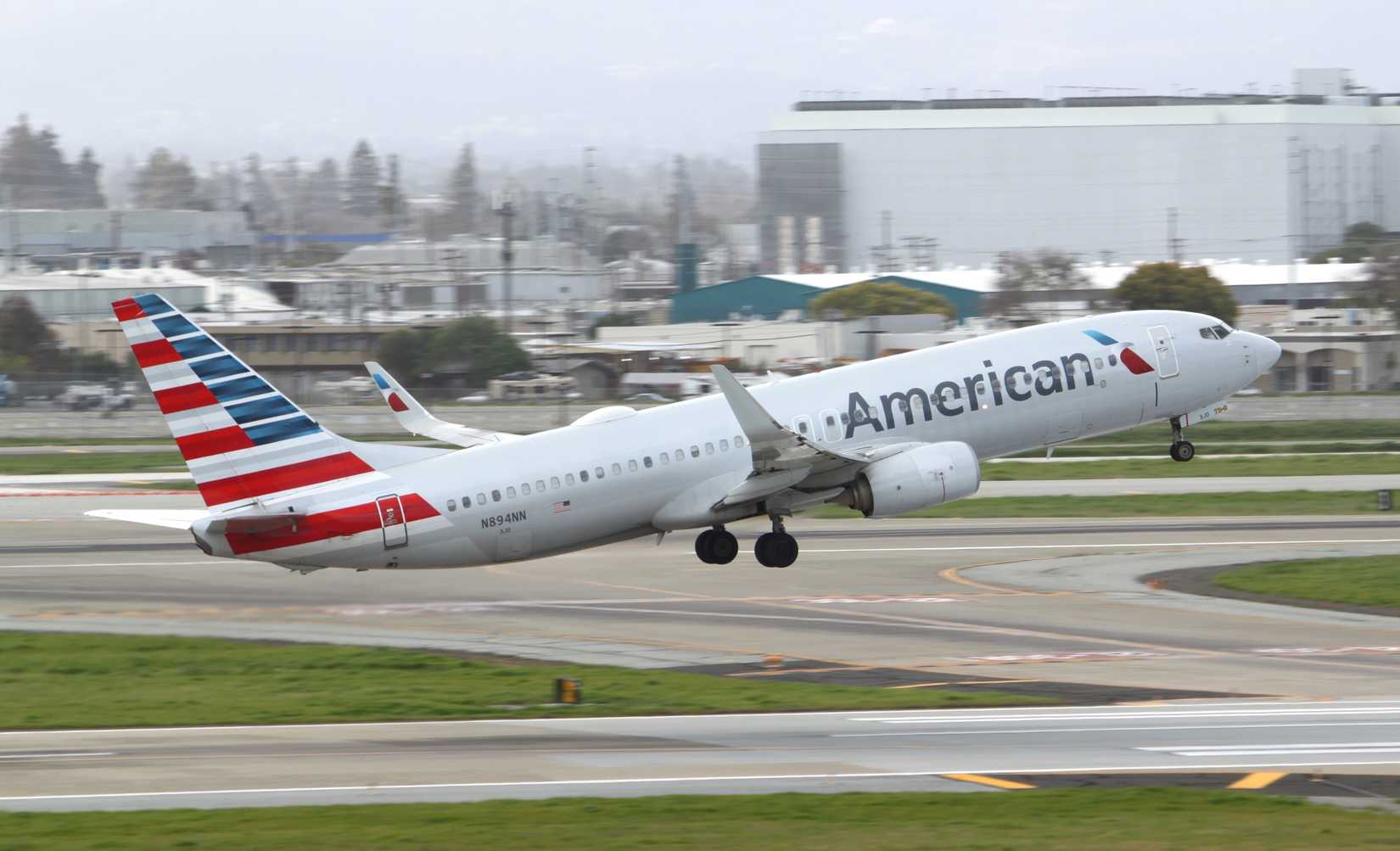 American Airlines Boeing 737-800 takeoff green grass