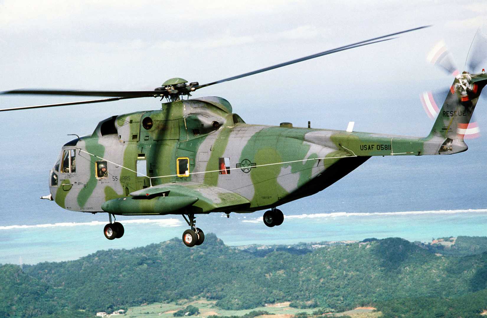 An air-to-air left side view of a CH-3 Jolly Green Giant helicopter assigned to the 33rd Aerospace Rescue and Recovery Service
