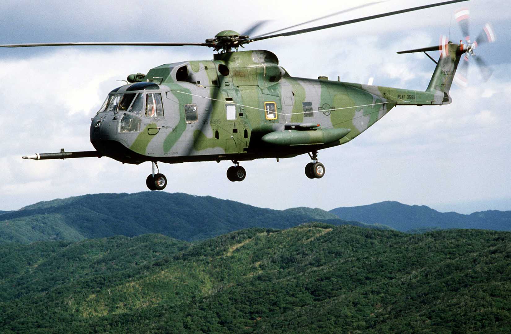 An air-to-air left side view of a CH-3 Jolly Green Giant helicopter