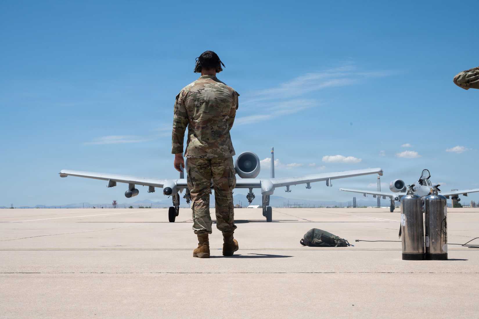 An Airman marshals an A-10C Thunderbolt II on the flightline following the completion of its final flight at Davis-Monthan Air Force Base