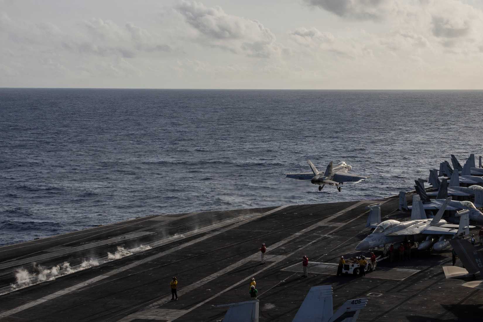 An FA-18E Super Hornet launches from the flight deck of Nimitz-class aircraft carrier USS Abraham Lincoln