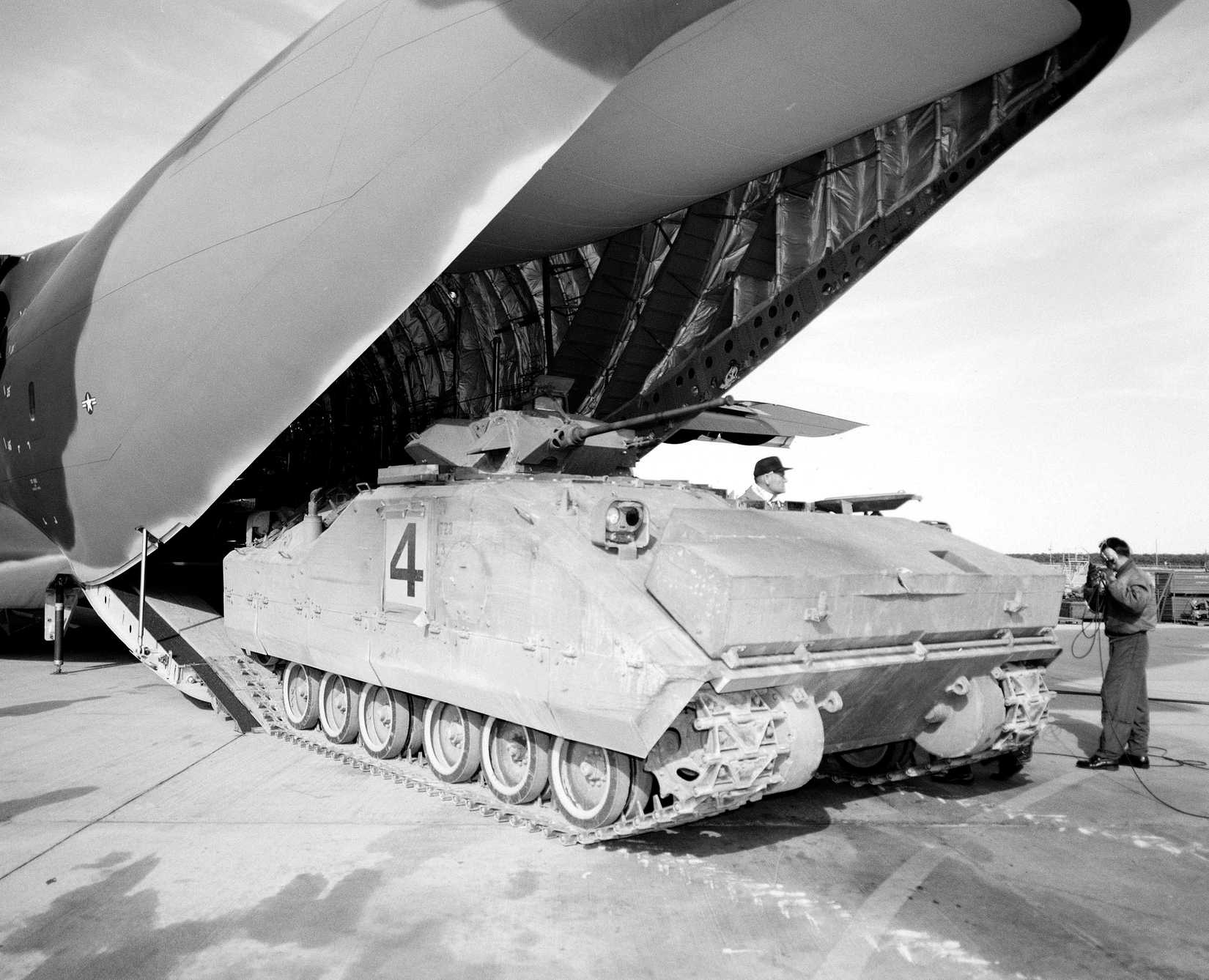 An XM-723 mechanized infantry vehicle is offloaded from a YC-15 aircraft during a heavy loading test