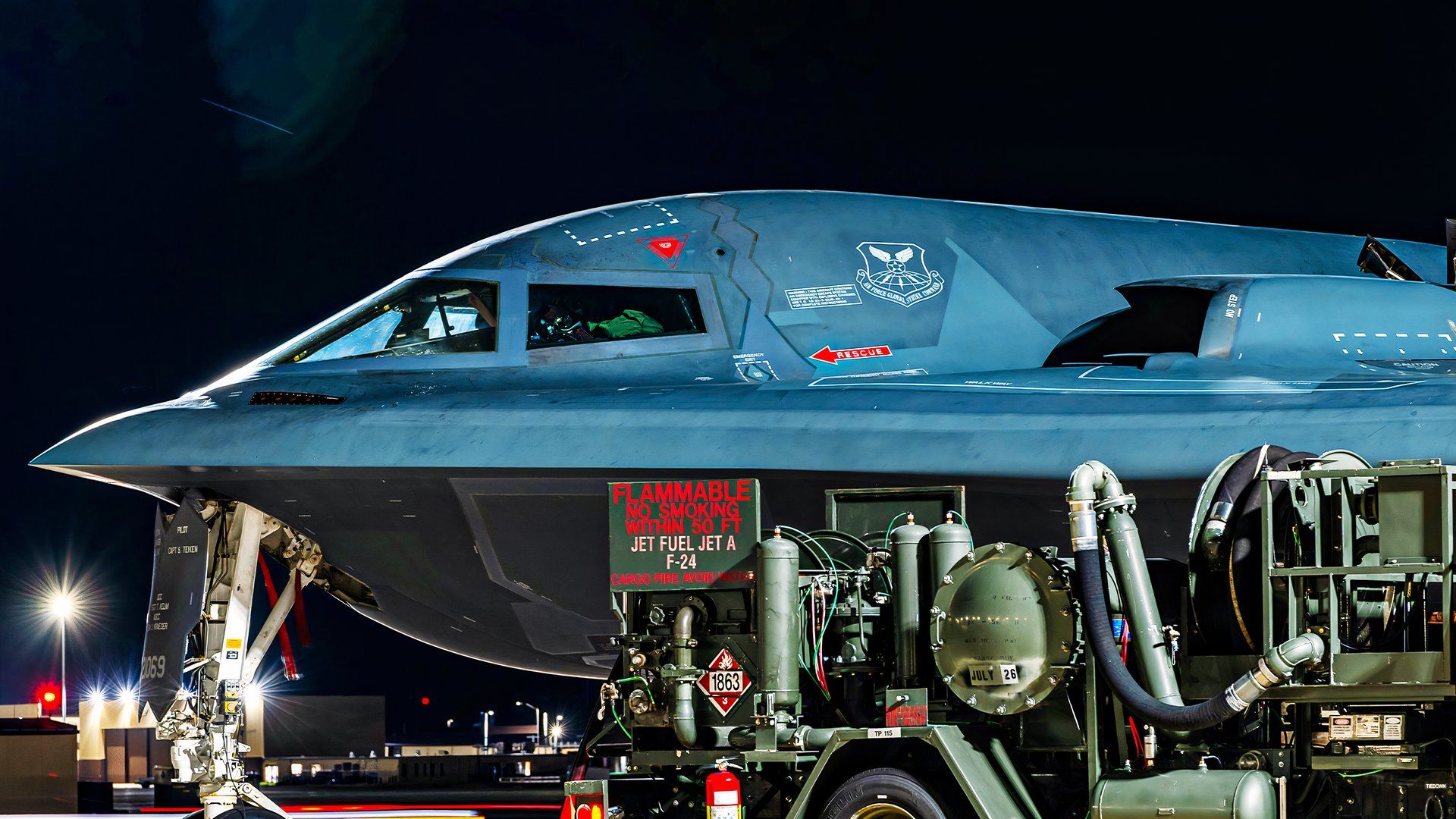 A photo of a B-2's nose section, while parked on the tarmac, possibly preparing for flight. 