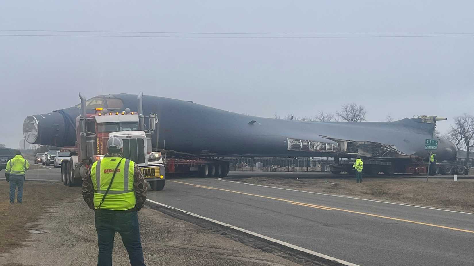 Contract crews along with Sedgwick County Sheriff’s Office deputies control traffic as a B-1B Lancer makes a tight turn at 47th Street South and Greenwich Road in Wichita, Kansas