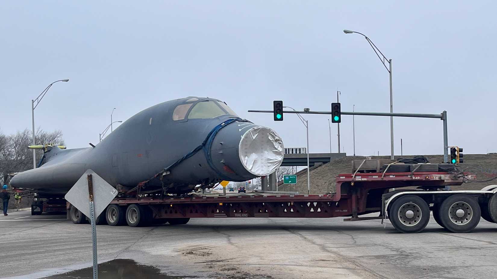 Drivers navigate a B-1B Lancer around obstructions en route to Wichita State University’s National Institute for Aviation Research as part of a research partnership in Wichita, Kansas, Jan. 27, 2024.