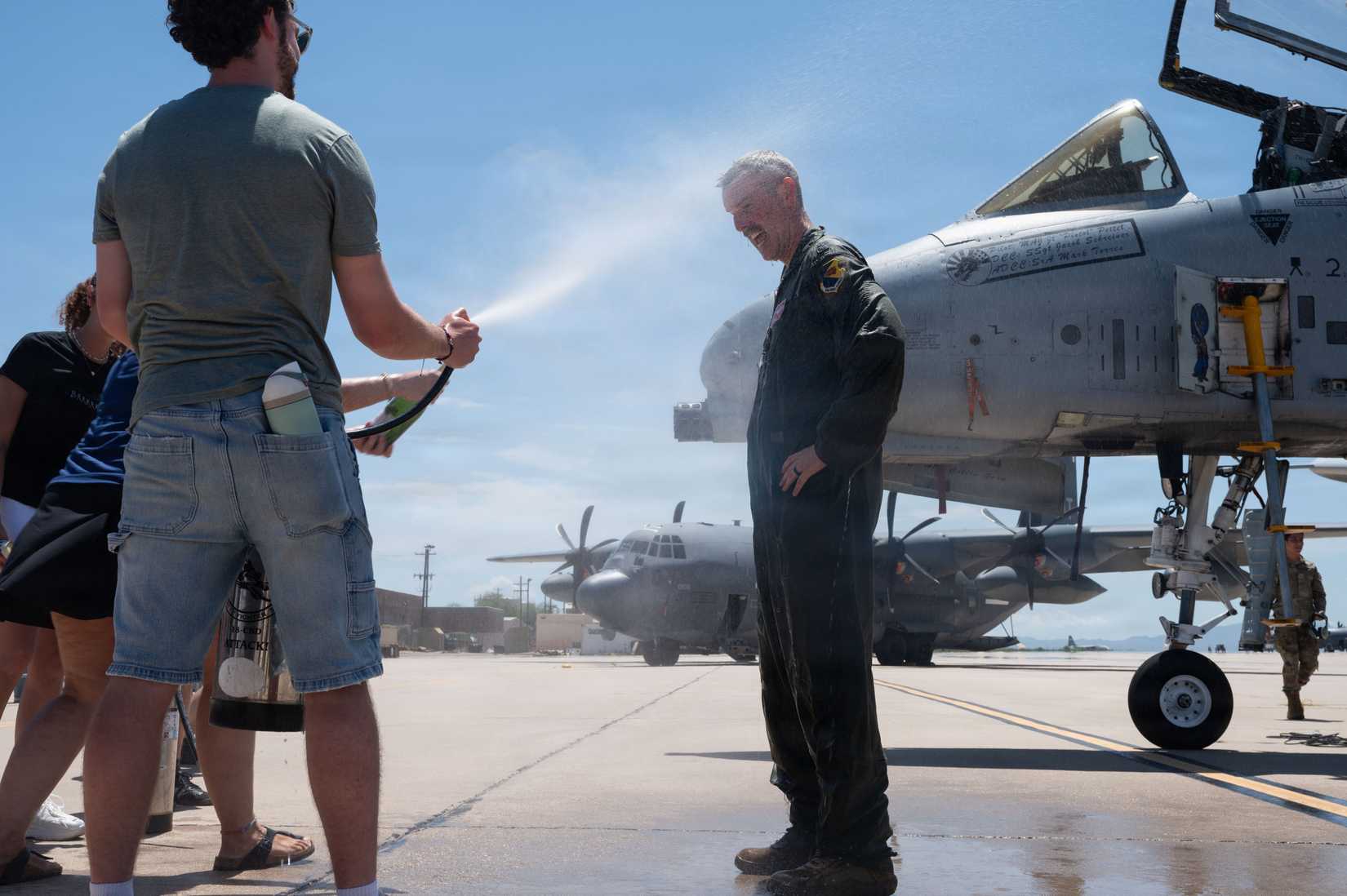 Lt. Col. Rodney Dwyer, 355th Operations Group commander, is sprayed with water by family and friends following the completion of the final A-10C Thunderbolt II flight at Davis-Monthan
