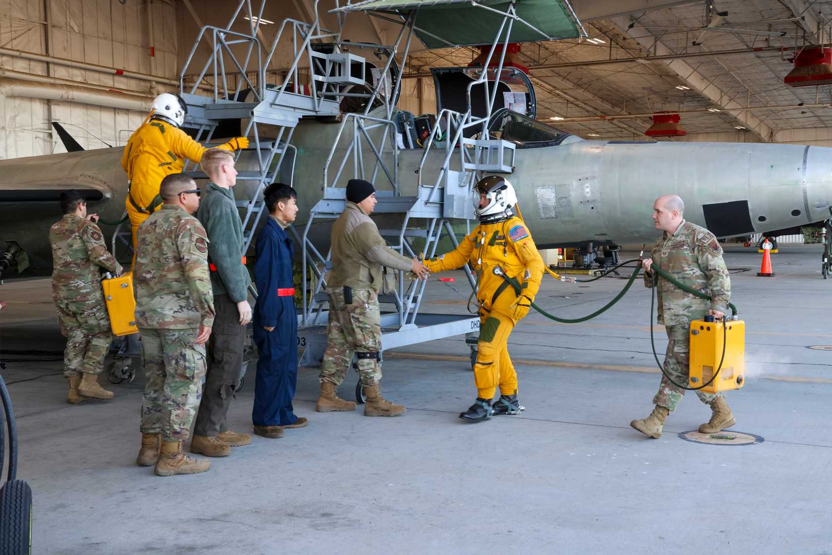 Maj. Brandon, Air Force Life Cycle Management Center (AFLCMC) Detachment 4 chief of flight test operations, shakes hands with the maintenance crew of TU-2S Dragon Lady 1078