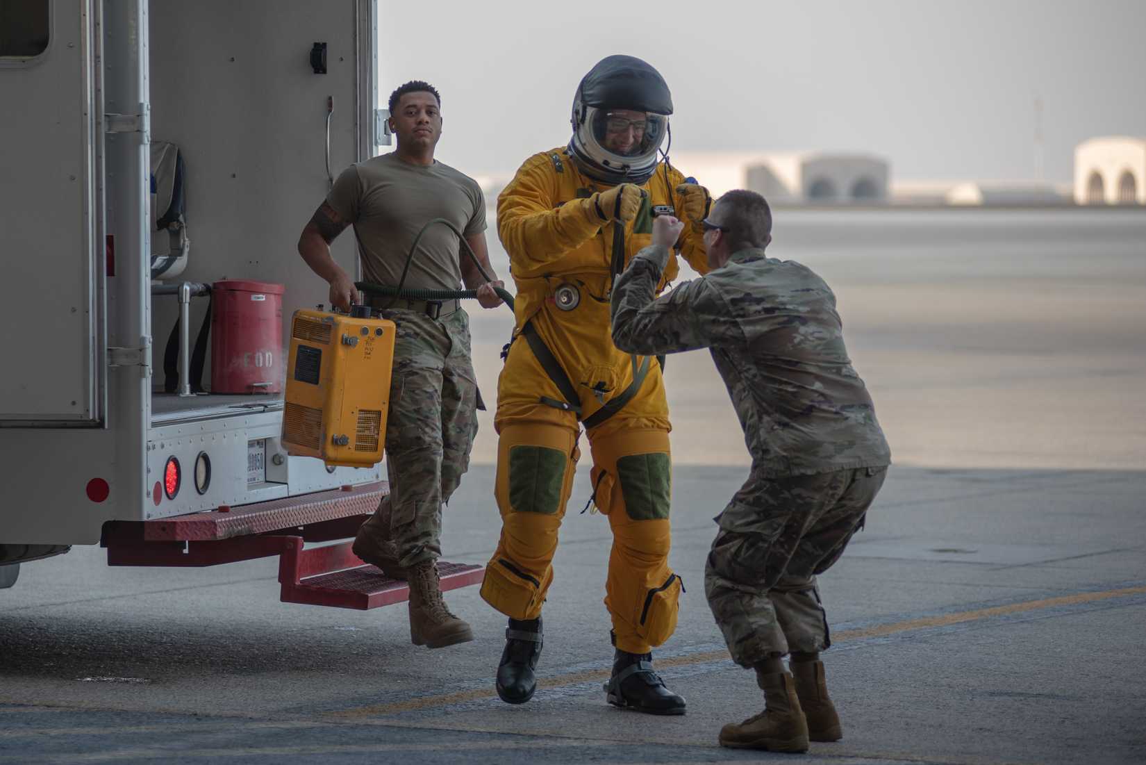 Maj. “Gobi” Gobrecht, 380th Air Expeditionary Wing Detachment One U-2 Dragon Lady pilot, fist bumps, Staff Sgt. John Patterson, 380th Expeditionary Operations Group medical technician