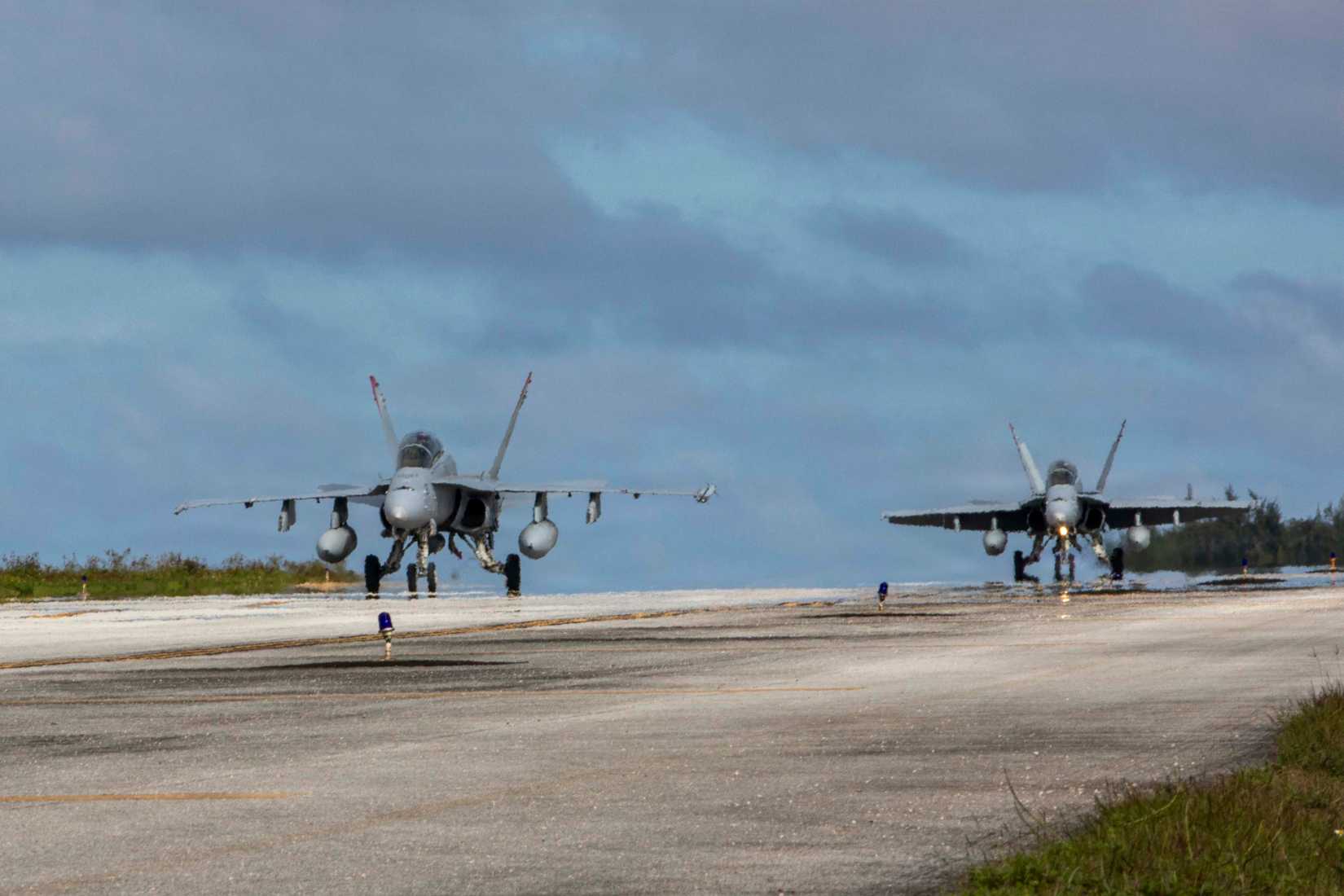 Marine Corps FA-18 Hornet aircrafts with Marine Fighter Attack Squadron (VMFA) 232, Marine Aircraft Group 12, 1st Marine Aircraft Wing, taxi the flight line during an Aviation Training Relocation program at Tinian