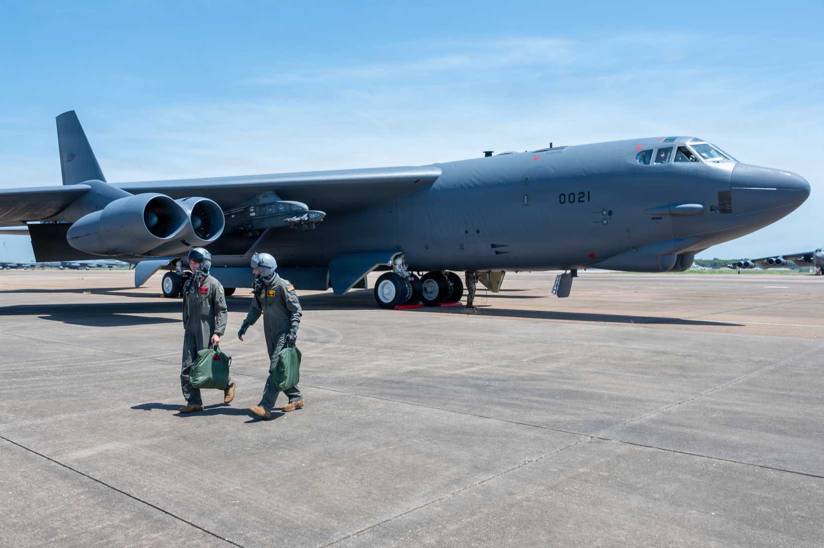 Navy Adm. Rich Correll,commander, Strategic Command, disembarks from a B-52H Stratofortress aircraft with Air Force Capt. Levi Hilgenhold, 96th Bomb Squadron pilot