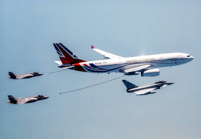 A photo of an RAF Voyager with with two F-35 fighters about to receive fuel and a Eurofighter Typhoon, flying over water.