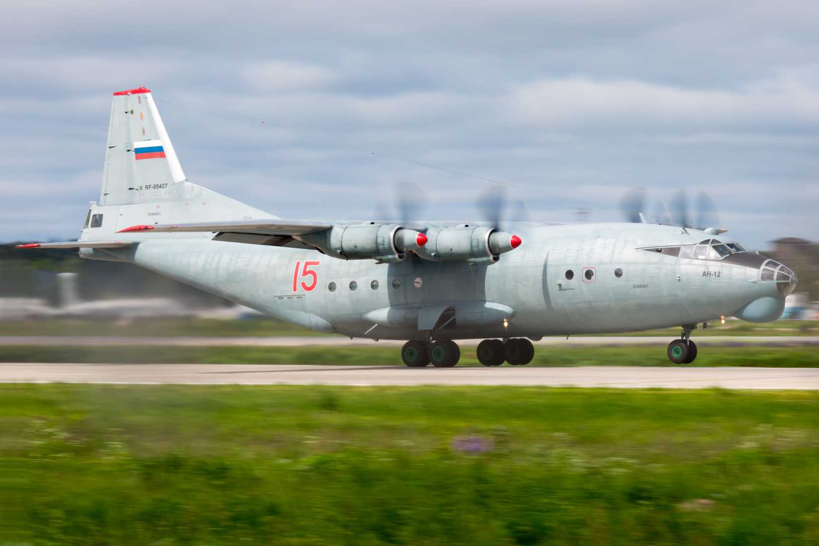 Military cargo aircraft Antonov An-12 of Russian Air Force taxis on the runway of the airfield.