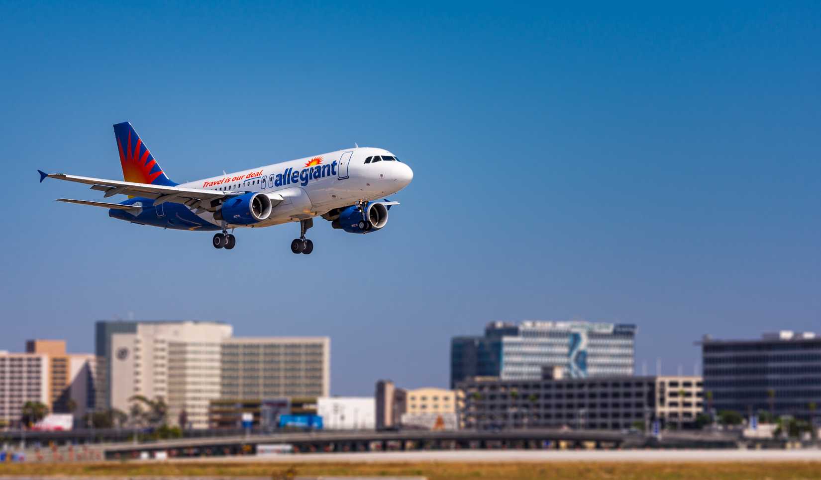 Los Angeles, CA / USA - July 7, 2020.  An Allegiant Airlines Airbus A320 on final into Los Angeles.  The airplane is only a few feet above the ground and the landing gear has been extended