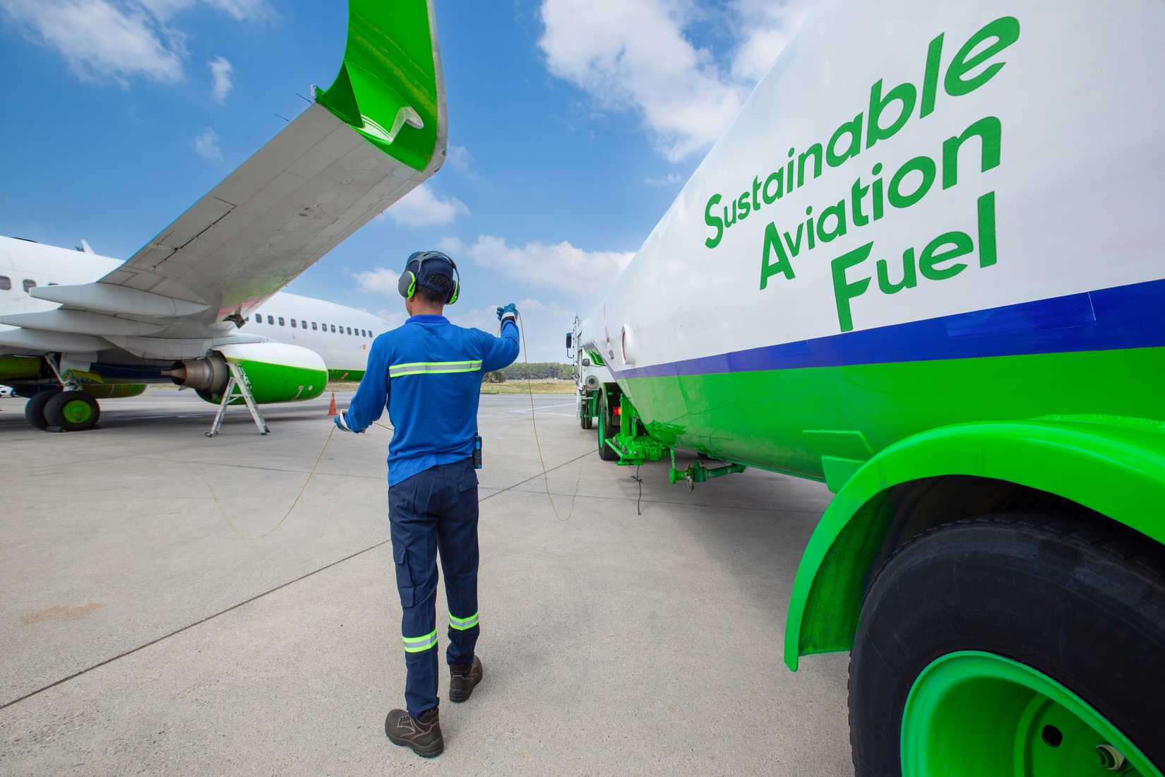 Technician refueling private jet with SAF at the airport