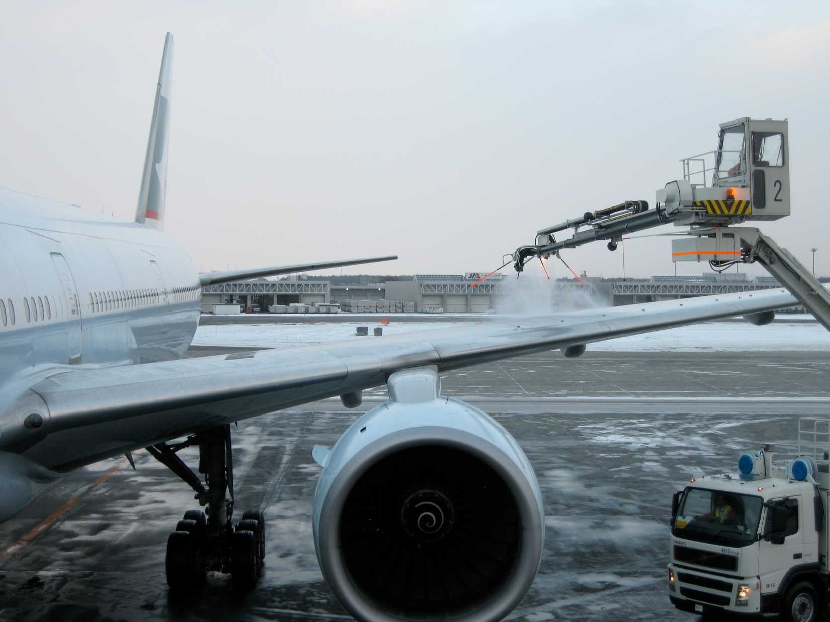 Incheon, South Korea. 06-23-2008.  A Cathay Pacific Boeing 777 commercial aircraft underwent deicing procedure by deicing truck and ground engineer, in cold sub-zero weather condition