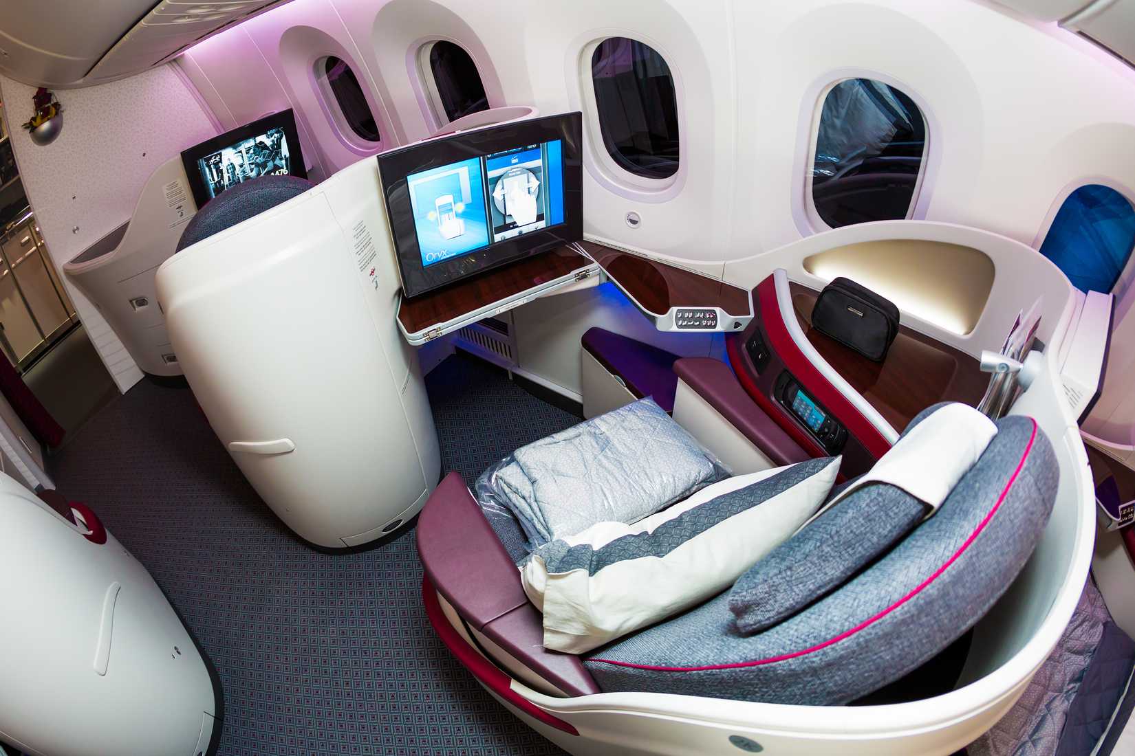 Dubai, UAE - NOVEMBER 11, 2015: Qatar Airways Boeing 787 Dreamliner business class seats. Qatar Airways business class cabin on November 11, 2015 in Dubai