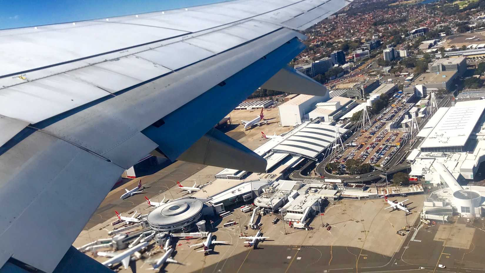 A wing shot of an aircraft taking off from Sydney Airport