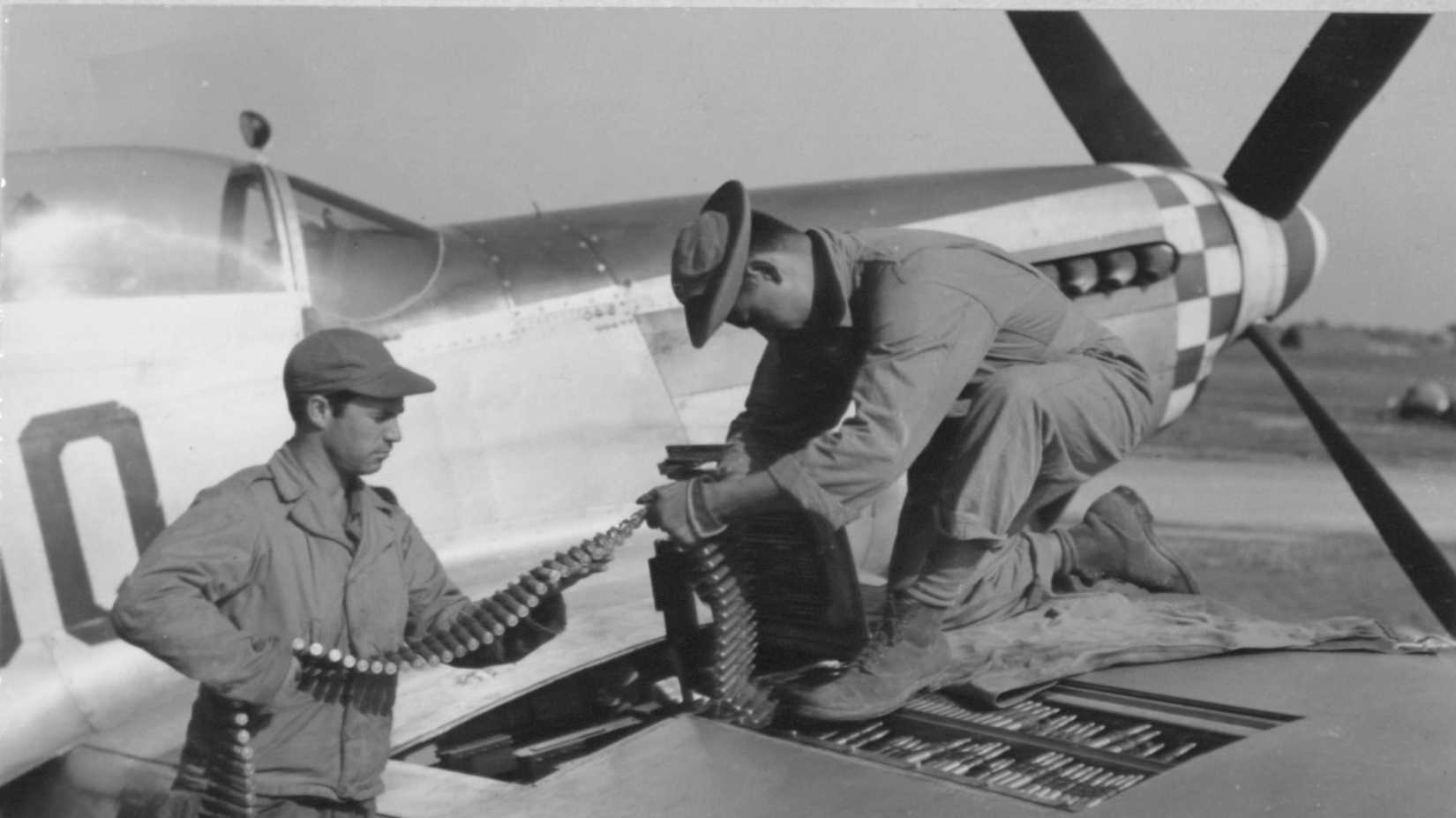 The 503rd Armament Group At Work Putting Ammunition Belts In A North American P-51 %22Mustang%22 In England. 3 September 1944.