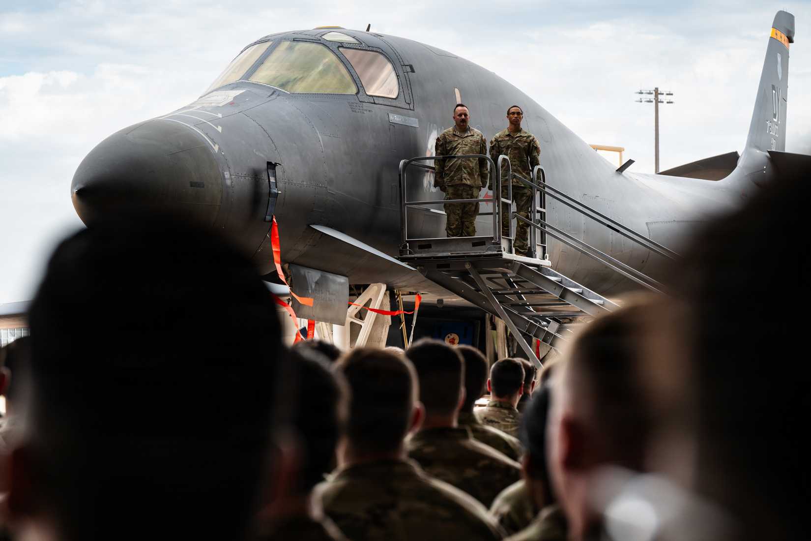The 7th Bomb Wing watch as the new wing commander’s name is unveiled on a B-1B Lancer during a change of command ceremony at Dyess Air Force Base,