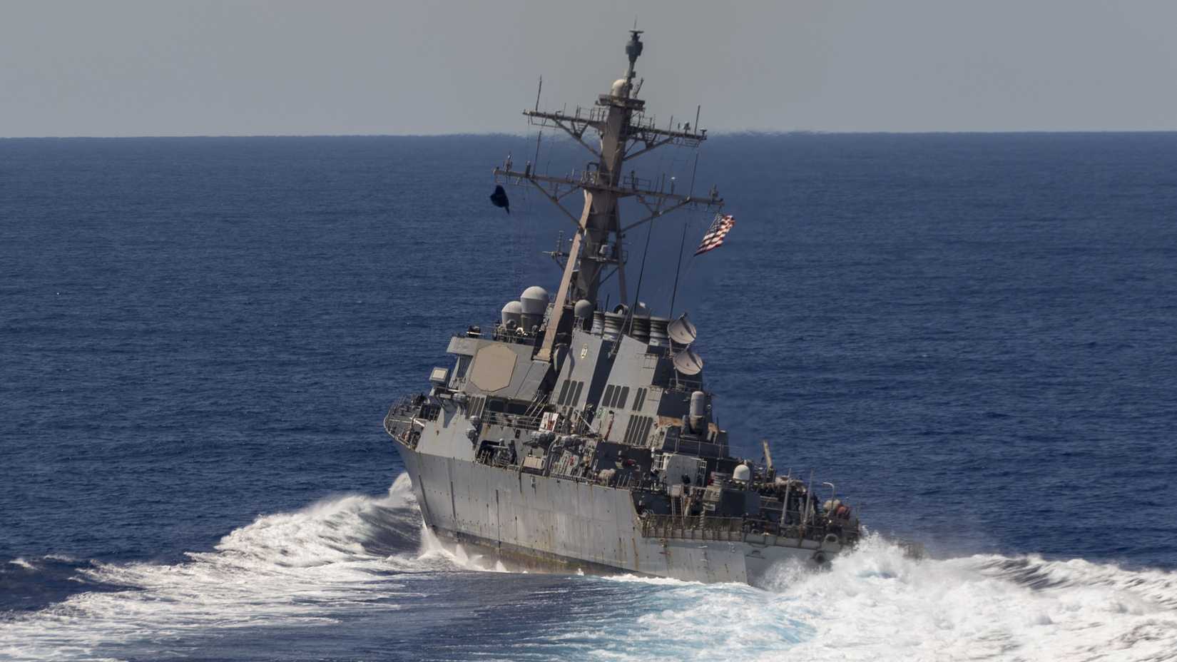 The Arleigh Burke-class guided-missile destroyer USS Mahan (DDG 72) breaks from formation