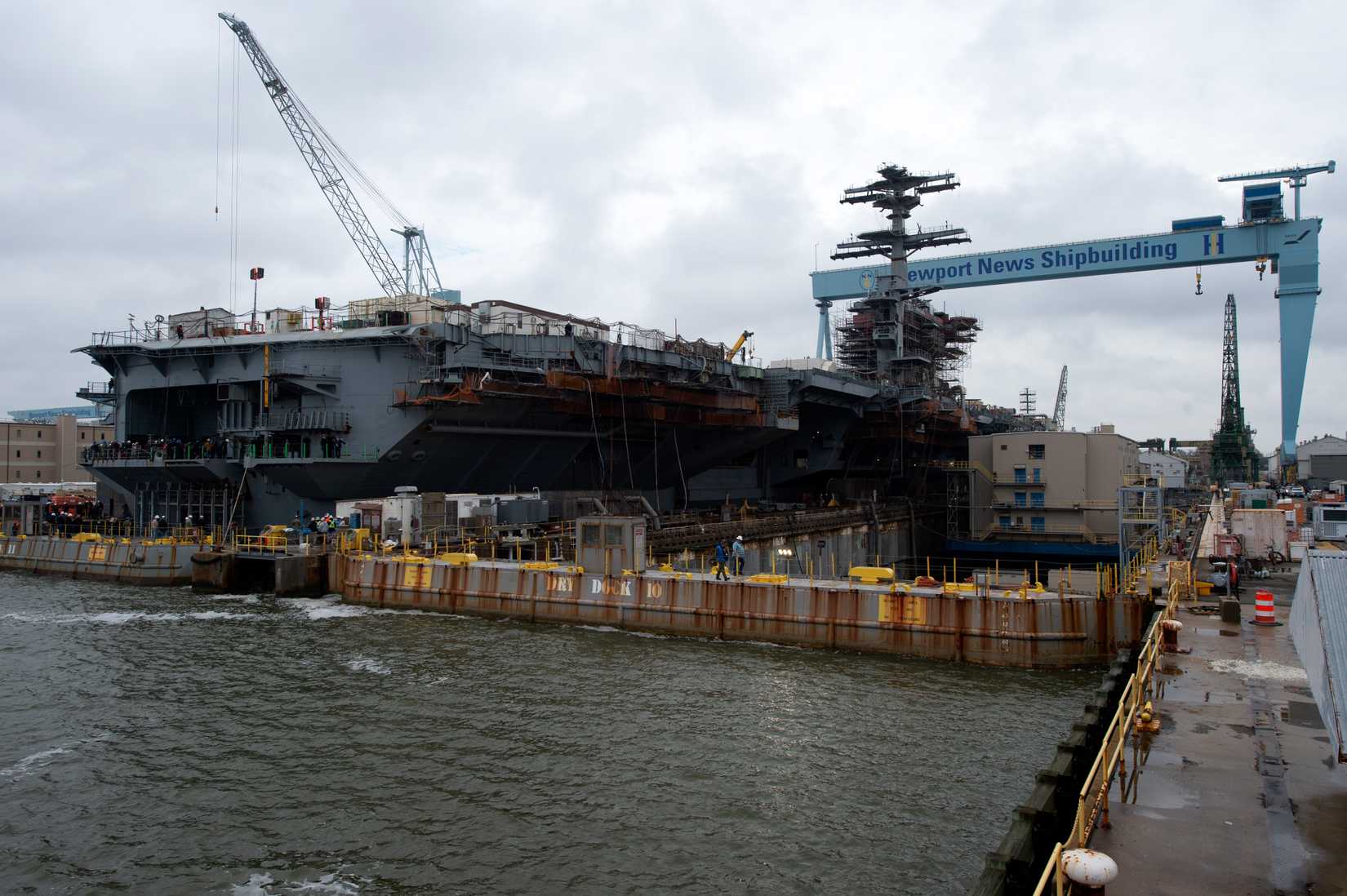 The Nimitz-class aircraft carrier USS John C. Stennis (CVN 74) dock while the dry dock floods in Newport News, Virginia