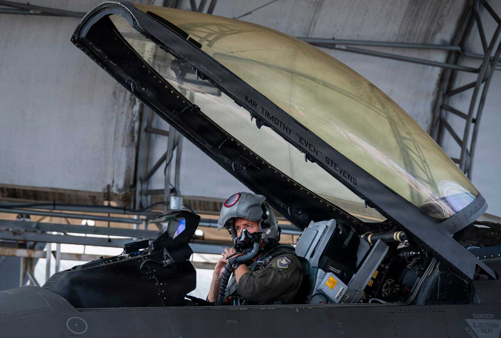 Tim Stevens, 40th Flight Test Squadron test pilot, adjusts his helmet before a VENOM test flight June 26, 2026, at Eglin Air Force Base