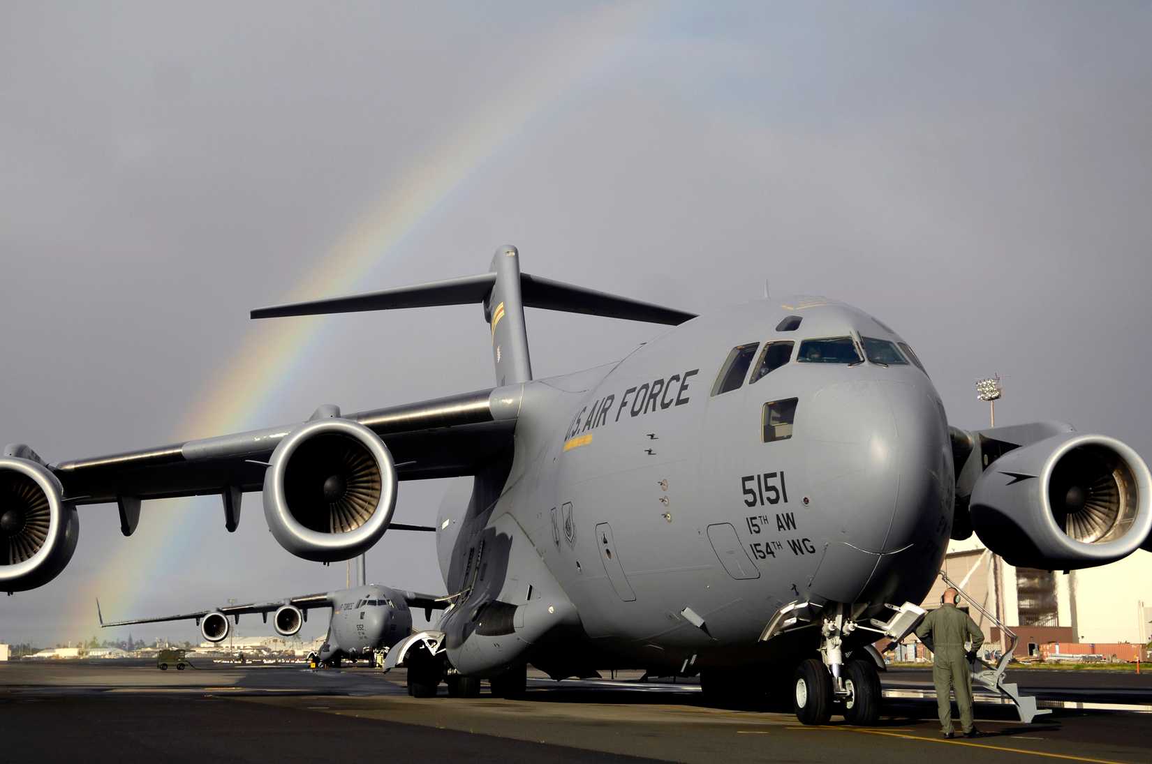 pre-flights check on a Boeing C-17 Globemaster III at Hickam Air Force Base, Hawaii for a local area training mission of the 535th Airlift Squadron