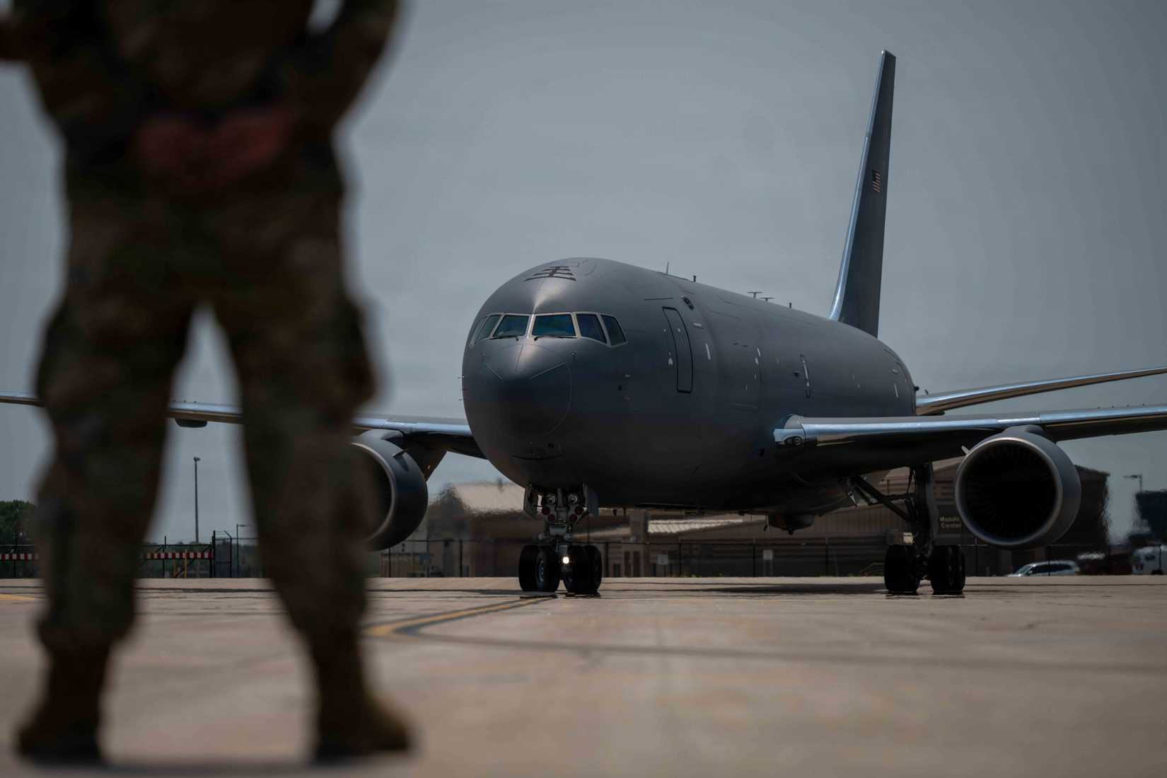 A 22nd Air Refueling Wing Airman marshals a new KC-46A Pegasus from Boeing