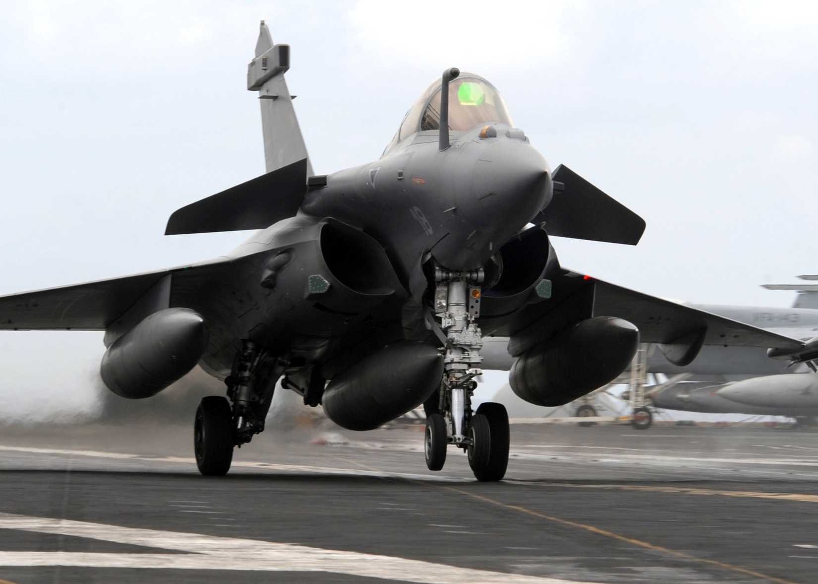 A French Dassault Rafale performs a touch and goes on the flight deck of aircraft carrier USS Dwight D. Eisenhower