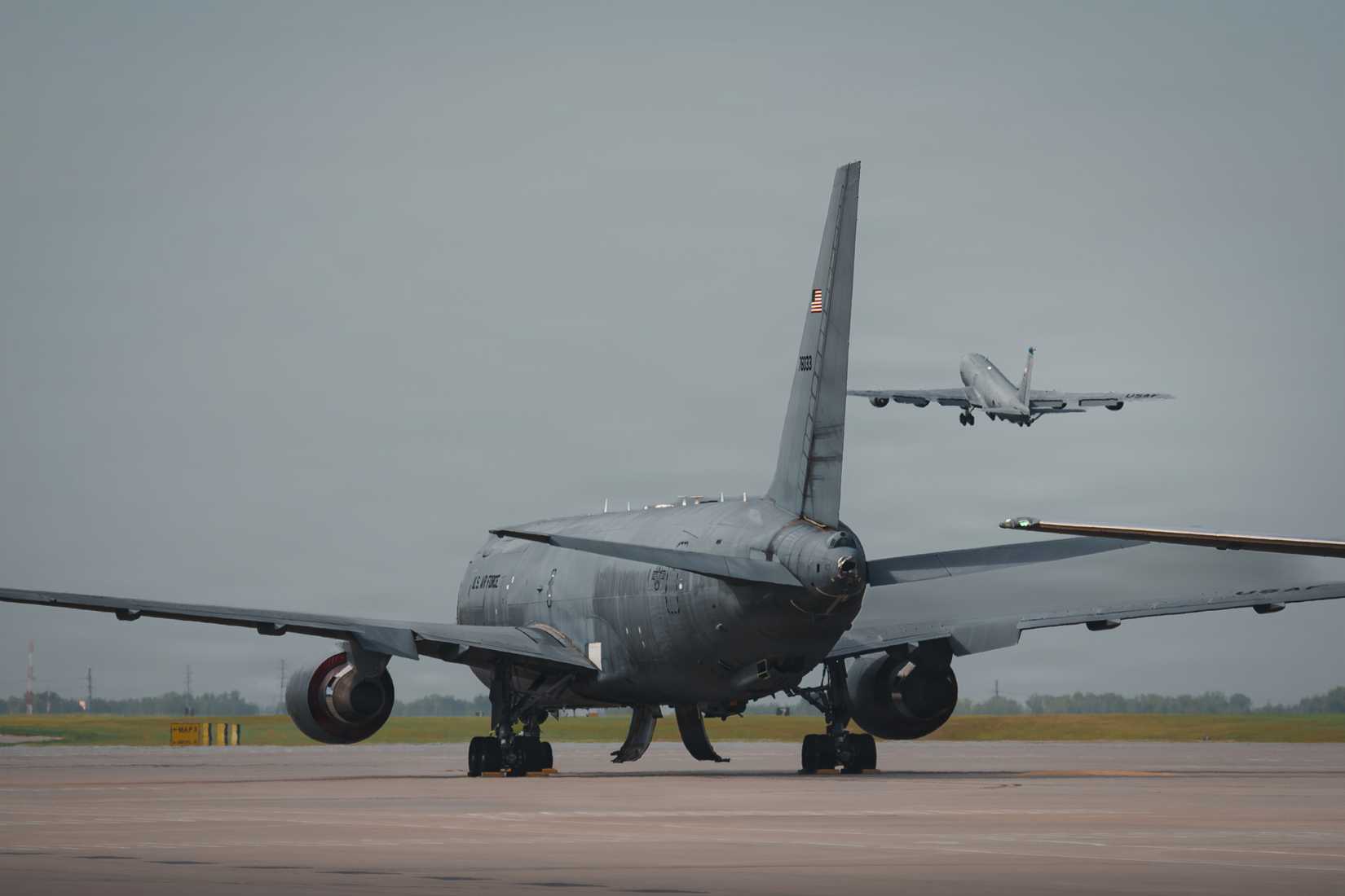A KC-135 Stratotanker departs over a KC-46 Pegasus at McConnell Air Force Base