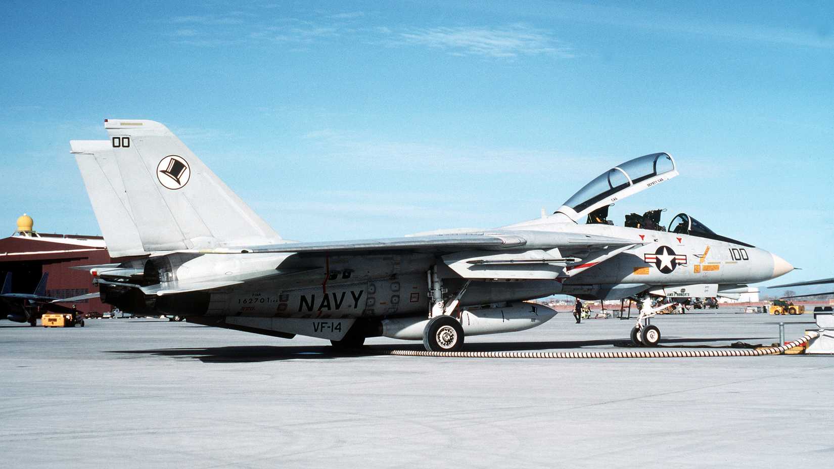 A right side view of Fighter Squadron 14 (VF-14) F-14A Tomcat aircraft being serviced on the flight line