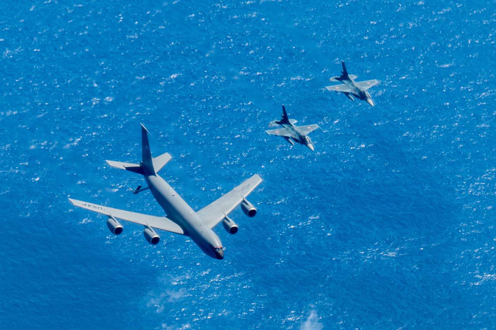 A U.S. Air Force KC-135 Stratotanker assigned to the 909th Air Refueling Squadron, and two Japan Air Self-Defense Force Mitsubishi F-2s
