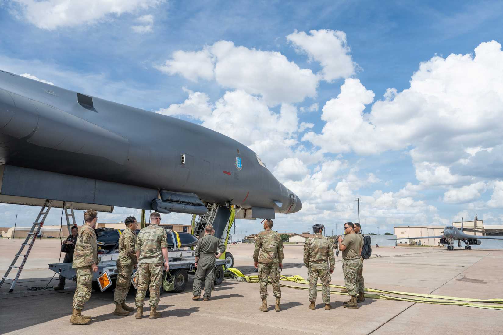 Air Force maintainers, aircrew and observers stand by a B-1B Lancer