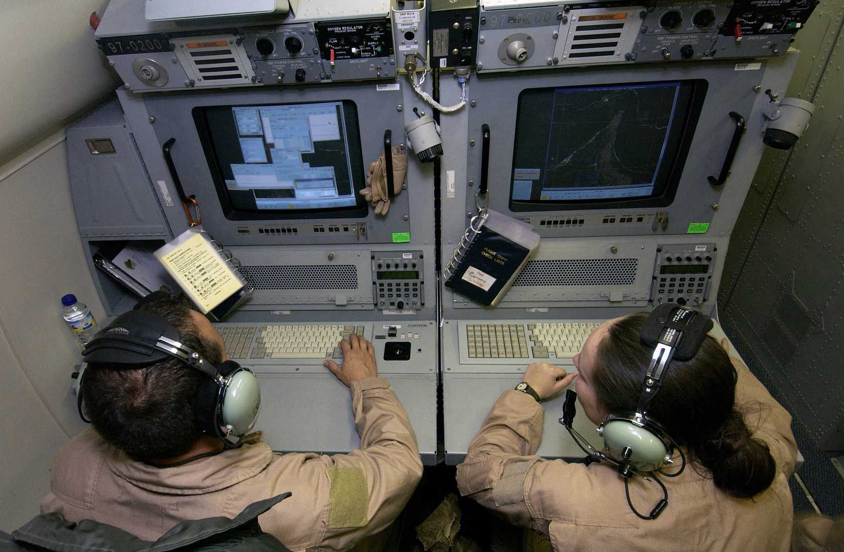Airborne Intelligence Technicians monitor consoles aboard a USAF E-8C Joint Surveillance Tracking Acquisition Reconnaissance System (JSTARS)