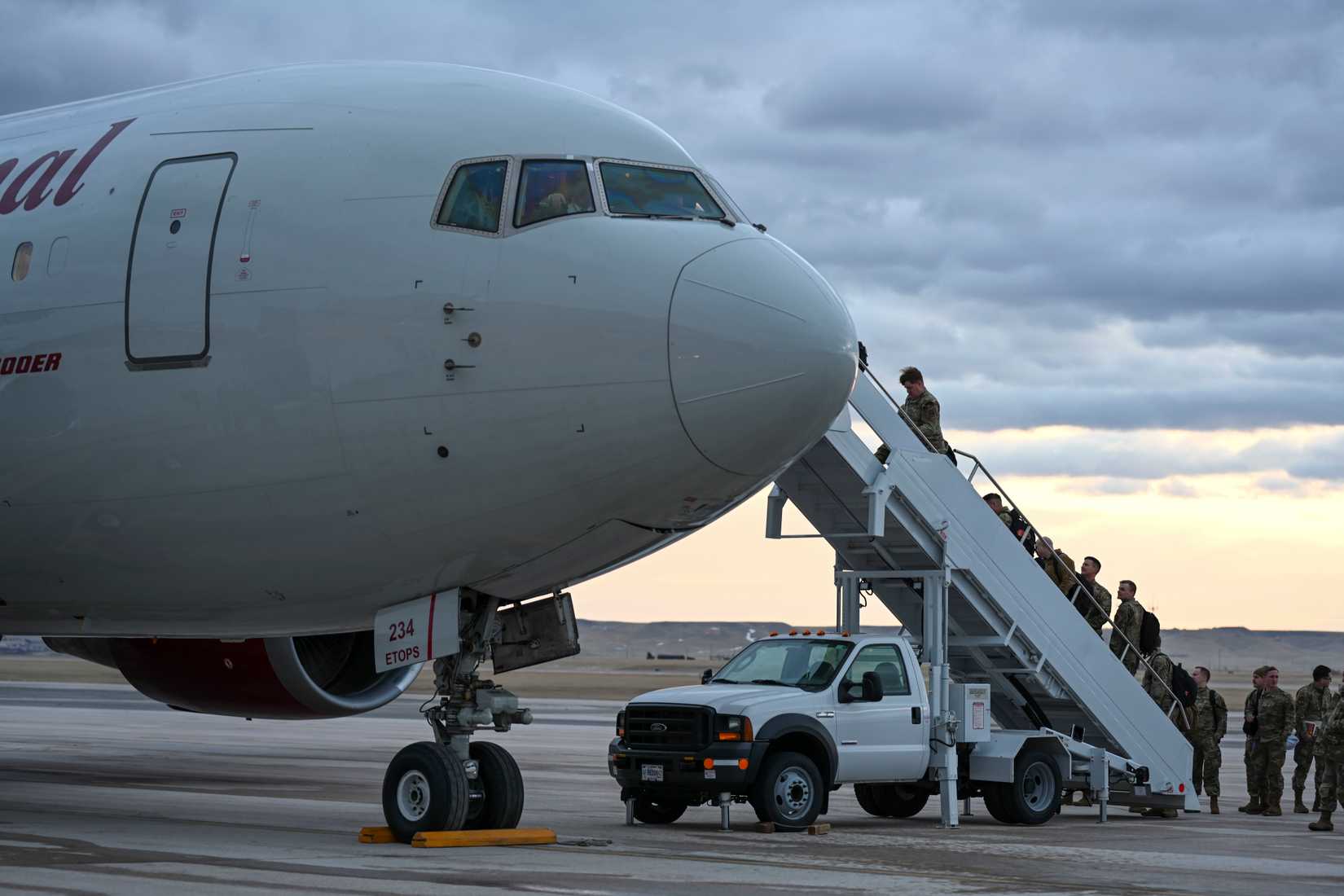 Airmen with the 28th Bomb Wing board a Boeing 777 for a Bomber Task Force mission to the Indo-Pacific at Ellsworth Air Force Base