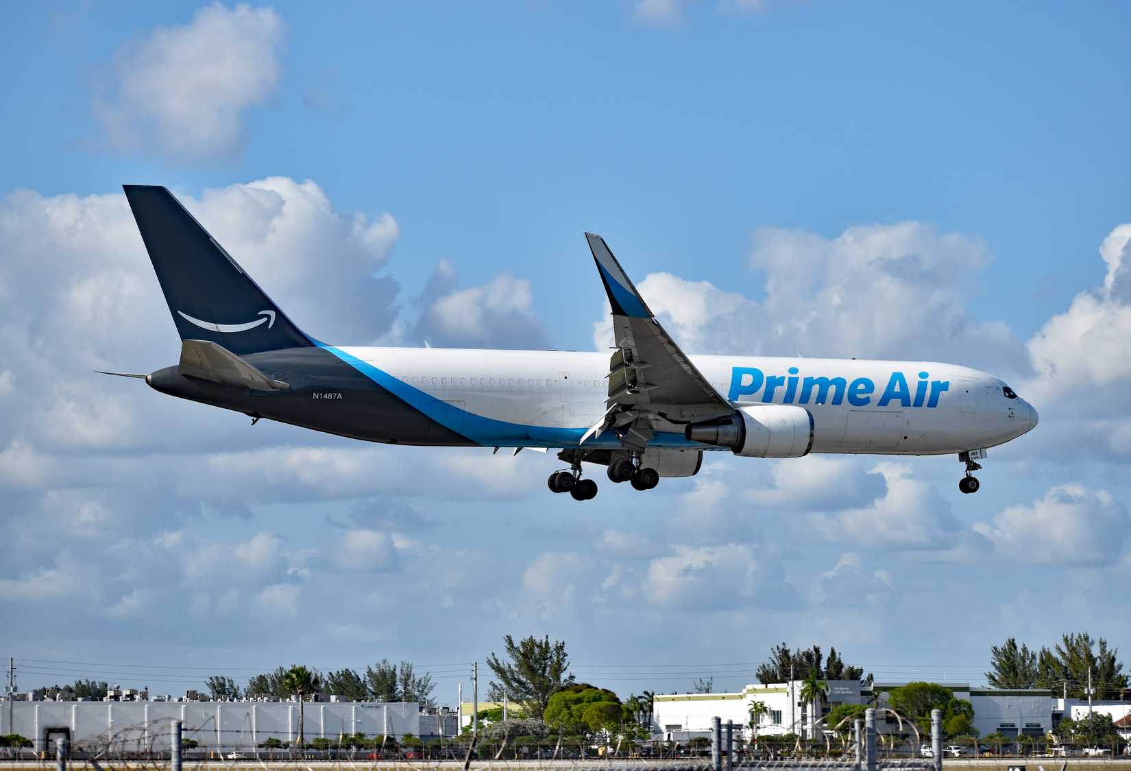 An Amazon Prime Air Boeing 767-300 freighter airplane, N1487A, about to land at Miami International Airport (MIA)