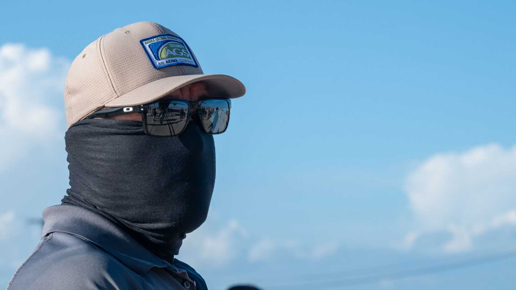 An Immigration and Customs Enforcement officer stands on the flight line at Naval Station Guantanamo Bay, Cuba
